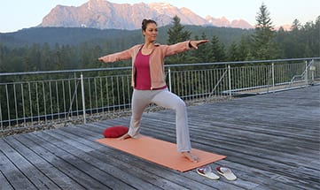 Yoga auf der Dachterrasse vor Bergpanorama