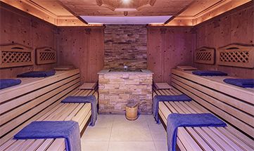 Bio Sauna mit Holzelementen und blauen Saunatüchern