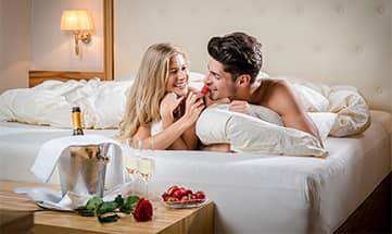 Paar genießt gemeinsam Erdbeeren und Sekt