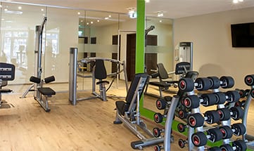 Fitnessraum mit vielen verschiedenen Geräten